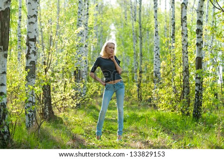 Pictures of the young blonde in a birch grove in the spring