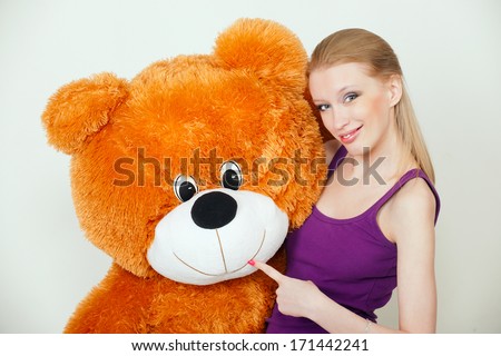 young blond woman with a big teddy bear