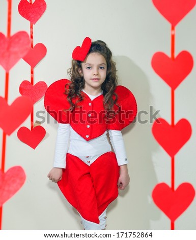 girl in red clothes with red paper hearts handmade