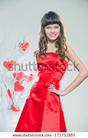 girl in red clothes with red paper hearts handmade
