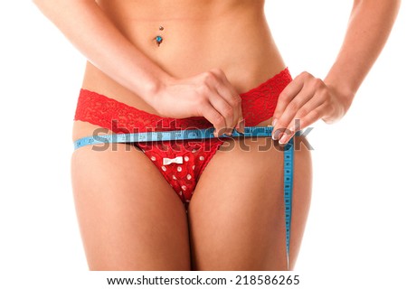 Young woman in red lingerie measuring its volume. Chest, waist, hips. Isolation on a white background.