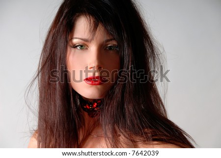portrait of a brunette girl with red lips and red necklace