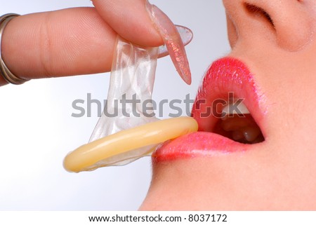 stock photo : mouth of a girl with pierced tongue licking a condom