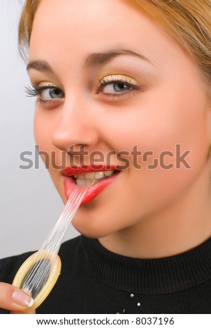 stock-photo-close-up-blonde-girl-is-holding-a-condom-with-surprised-face-8037196.jpg