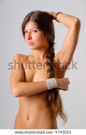 stock photo topless brunette girl is covering her breasts with hand on the 