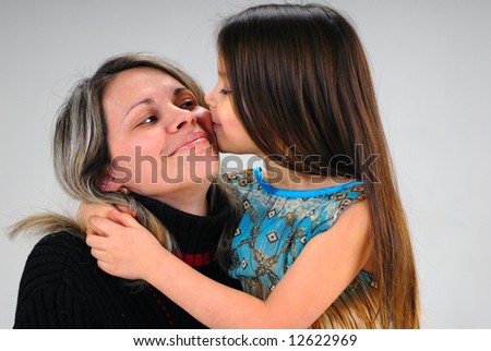 cute little baby girl kissing her mom with love