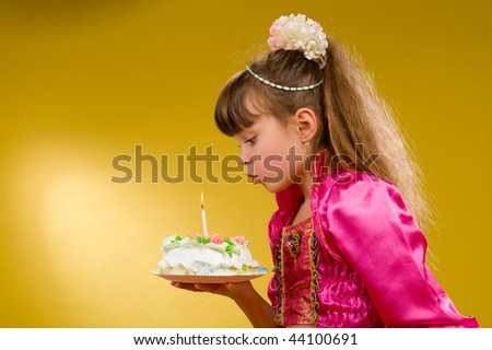 little boy and girl sit at a table on which stands the cake