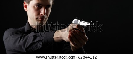 photo a young man drawing a gun in self defense studio shoot