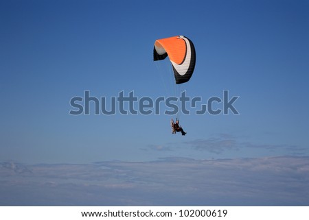 para-motor glider flyes in the air