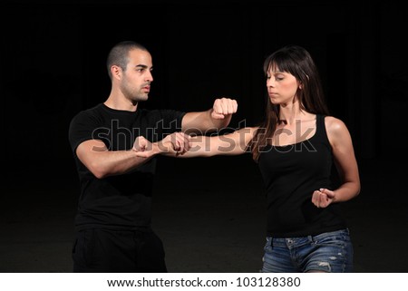 martial arts instructor exercising with young girl