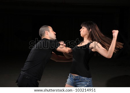martial arts female instructor exercising with young man