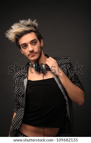 portrait of a young guy listening music on a head phones
