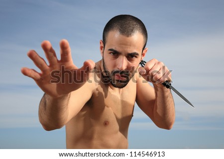 martial arts instructor exercising with a knife outdoor