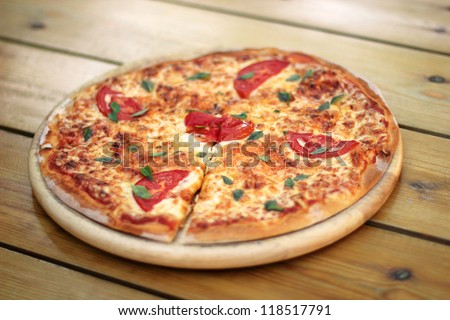 fresh pizza margarita on a wooden plate selective focus