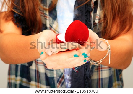 close up of hands holding a ring box
