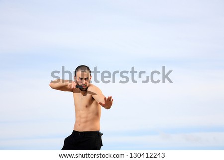 martial arts instructor holding a knife and practicing outdoor