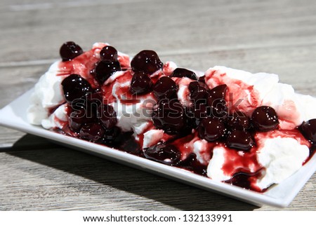close up of yogurt served on a plate with cherry marmalade