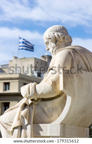 greek ancient statue and the greek flag in the background