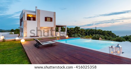 big  pool and luxury villa in the afternoon