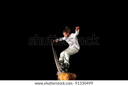 Inline skater doing tricks with a big rope at night