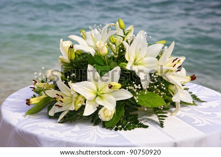 Bouquet of flowers on a table by the sea in Greece