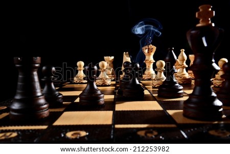 Concept, Chess Game Raging On with Firing Smoke, Black Background