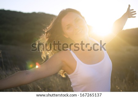 Beautiful Young Woman Stretching Her Arms Joyfully Praising The Beauty Of Life.
