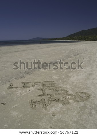 Life is hard drawn in sand on the beach