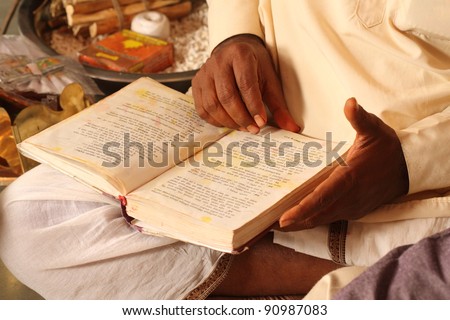 indian old man reading prayer book