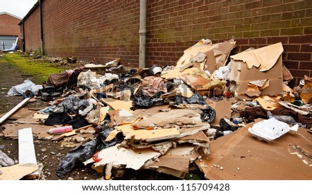 general building waste dumped in alley, an illegal social issue, fly tipping causing environmental pollution