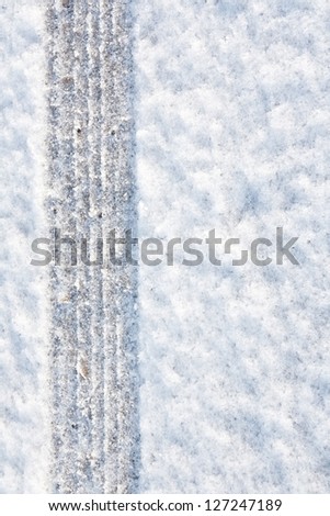 tyre tracks imprinted into fresh snow a great background for rallies or four wheel drive carsty
