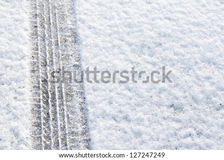 tyre tracks imprinted into fresh snow a great background for rallies or four wheel drive cars