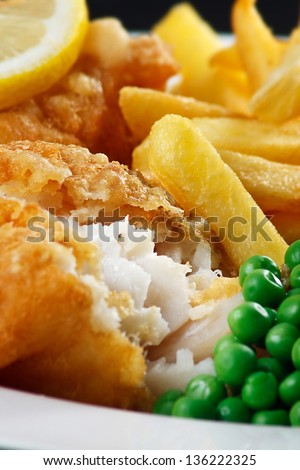 Detail Of Traditional Fish And Chips With Peas And A Slice Of Lemon.