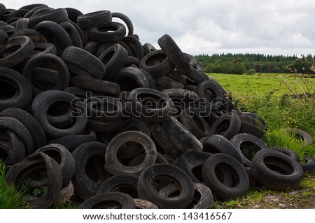 Pile of old vehicle tires dumped in the countryside by farmer