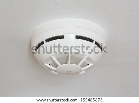 Ceiling Mounted White Fire Detector Used To Activate Warning Systems In Residential Buildings