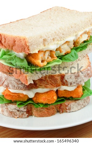 Fresh Fish Finger Sandwich close up on a white serving plate