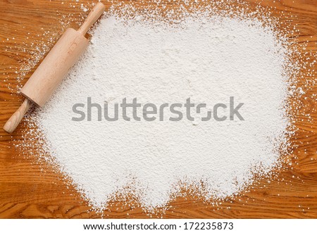 White flour on a wooden table creating a text area for insertion of your custom message or recipe