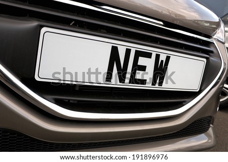 Number plate of a new car for retail sale on a motor dealers forecourt all logos removed
