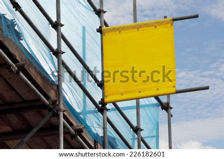 Blank scoffolding sign for advertising a scaffolders business erected on some scaffold a prime vantage point for advertising.