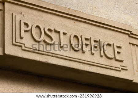 Post Office Building entrance carved in stone above the door of the postal service