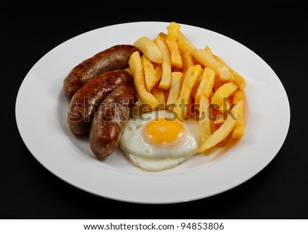 Close up of Sausage, egg and chips. A traditional British Dish