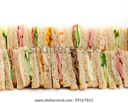 A selection of Sandwiches with various fillings at a buffet with text area