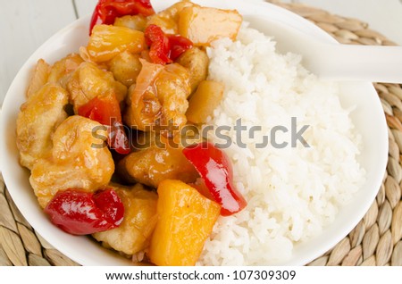 Sweet and Sour Chicken with pineapple and red bell peppers served with steamed rice