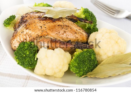 Roast Dinner - Roast partridge served with cauliflower and broccoli. Traditional British Sunday and Christmas meal.