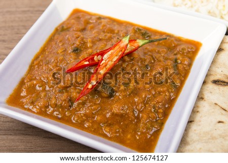 Keema Madras - Minced lamb curry garnished with chilies and served with rice and chapatis.