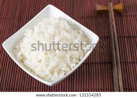 Rice - Bowl of steamed white rice and chopsticks.