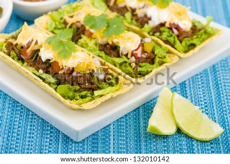 Beef Tacos - Shredded beef taco trays topped with salsa, sour cream and grated cheese.