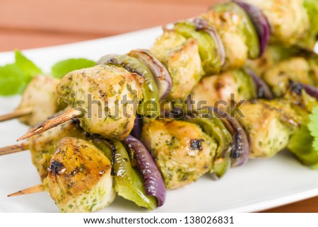 Lime, Mint & Coriander Chicken Kebabs - Marinated chicken with red onion and green peppers on skewers.