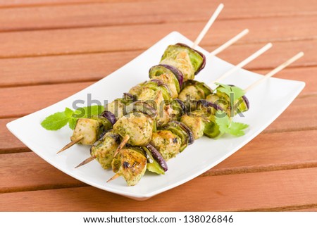 Lime, Mint & Coriander Chicken Kebabs - Marinated chicken with red onion and green peppers on skewers.