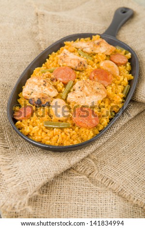 Paella Valenciana - Traditional Valencian paella with white rice, chicken, sausage, butter beans and green vegetables.